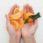 Hands cupped and holding bits of an orange used to illustrate an example of simplifying a spiritual dream