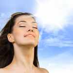 A woman enjoying sun and wind on her face representing God's Presence.